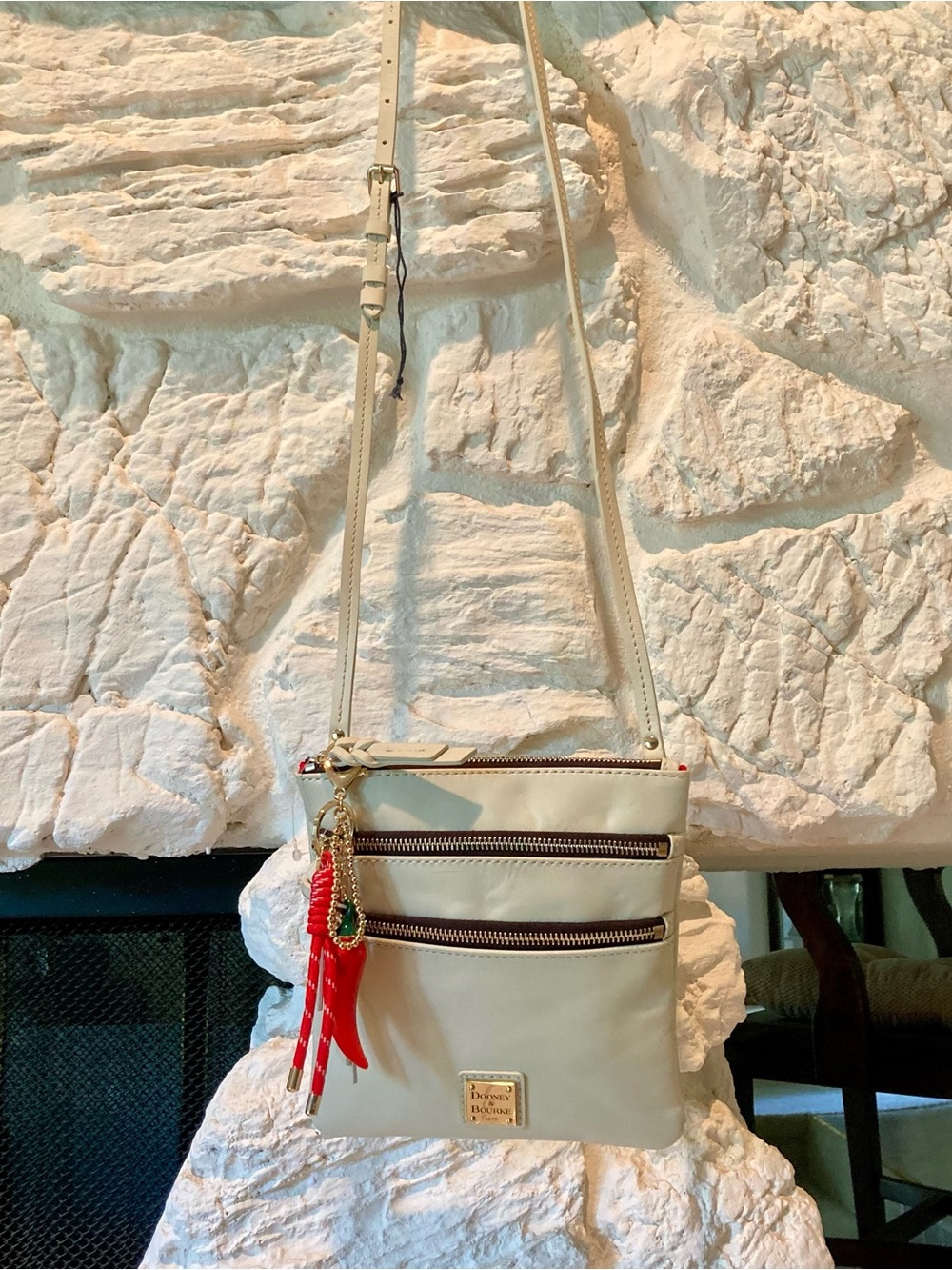 Dooney & Bourke Cream Crossbody with Red Tassel Charm